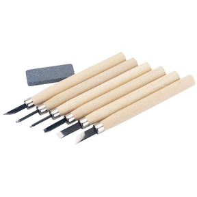 The Draper Wood Carving Set With Sharpening Stone (7 Piece) - CT6 includes six carving tools with Ramin handles and various steel blade types, as well as a gray sharpening stone.