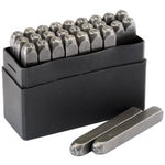 The Draper A - Z Letter Stamp Set, 3/16" - LS, made from hardened and tempered alloy tool steel, is neatly arranged in rows inside a black rectangular box, with two loose stamps positioned in front.