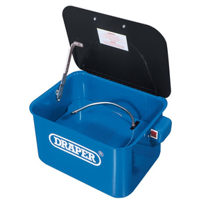 The Draper 230V Bench-Mounted Parts Washer, 12L - DPW2, features an open lid with an internal hose and nozzle system, a handle on the side, and the Draper brand name printed on the front. Made with durable steel construction, it includes an electric pump for efficient degreasing.