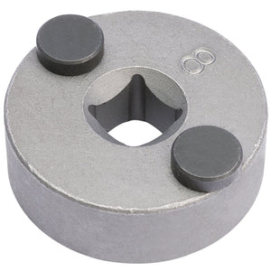 A round metal object featuring two black circular magnets and a square-shaped hole in the center, similar to the Draper Ford/Subaru Brake Piston Wind-Back Tool (CWBT).