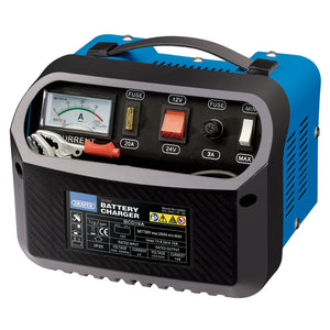 Image of a blue and black Draper 12/24V Battery Charger, model BCD18A, designed for lead acid batteries. It features an analog ammeter display, various fuses, and sockets for 12V and 24V. The device includes insulated copper leads, a carrying handle on top, a cable storage compartment, and its specifications are listed on the front.