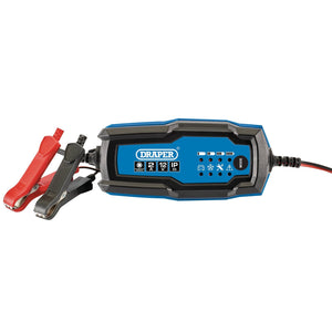 A blue and black Draper 12V Smart Charger and Battery Maintainer, Model BCI2, designed for 12V vehicle batteries with indicator lights and equipped with attached red and black clamps.