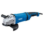 The Draper 230V Angle Grinder, 230mm, 2400W - AG2400/230D features a blue and black body, a three-position side handle, and a protective guard over the grinding disc. Additionally, this model comes equipped with a soft start feature for added safety.