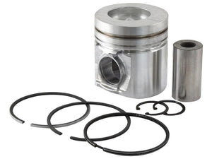 A collection of engine parts, including the Sparex | Piston & Ring Set with a metallic piston, cylindrical pin, and several chrome-plated rings for Case IH equipment, arranged on a white background.