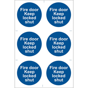 A pack of six blue circular stickers from Draper, known as the "Draper Fire Door Keep Locked' Mandatory Sign (Pack Of 6) - SS08." These durable PVC adhesive stickers feature white text stating "Fire door Keep locked shut," ensuring compliance with the BS5499 Standard. The stickers are printed with UV-resistant ink for long-lasting visibility.