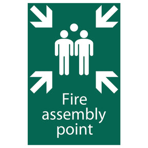 The Draper Fire Assembly Point - SS40 sign by Draper features a green and white design with three figures standing together, surrounded by four arrows pointing inward. It is made from UV-resistant PVC material.