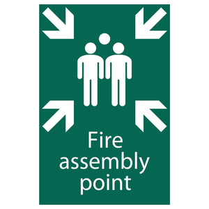 The Draper Fire Assembly Point - SS40 sign by Draper features a green and white design with three figures standing together, surrounded by four arrows pointing inward. It is made from UV-resistant PVC material.