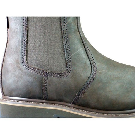 Close-up of a dark green leather Buckler *SPECIAL PRICE* JMCE Non-Safety Buckflex Dealer Boot (B1400), featuring detailed stitching, an elastic side panel, and a K3 Rubber Sole.