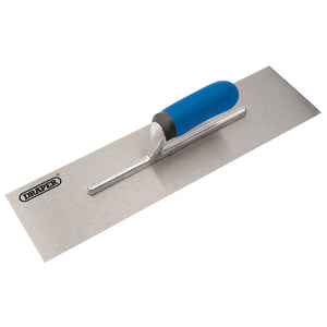 The Draper Soft Grip Plastering Trowel, measuring 120 x 455mm (model PLTSGW), is shown featuring a blue soft grip handle. The rectangular blade is made of hardened and tempered stainless steel, and the handle is centrally positioned on the tool. The brand name "Draper" is printed on the blade.