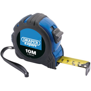 A Draper Expert Measuring Tape, model EMTRJT, features a 10-meter (33 ft) long and 25mm wide yellow nylon-coated blade within a blue and black ABS case. The tape measure comes equipped with a black wrist strap and a side clip, providing durability and flexibility for precise measurements with EC Class II accuracy.