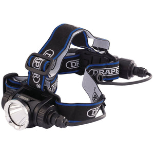 The Draper Rechargeable LED Head Torch, 10W - RHL4, is a black and silver headlamp branded with "DRAPER." It includes an adjustable elasticated headband and features a front light with a 900-lumen output, connected via cables to a rear battery pack.