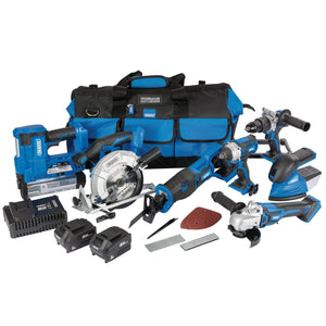 The Draper D20 20V Jumbo Kit, which includes brushless tools such as a saw, drill, and grinder along with various accessories, features an interchangeable battery system. The set comes with one 3.0Ah battery, one 5.0Ah battery, a charger, and is arranged neatly with the batteries and a black carrying bag in the background.