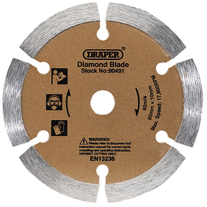 Circular diamond blade with four segments, labeled "Draper Segmented Diamond Blade, 85mm - DBSRD." Features usage and safety icons, a warning message, and specifications: 80mm, 85mm x 10mm, Max Speed: 17,000 RPM. Part of the Draper Storm Force range for precise cuts with adjustable depth.