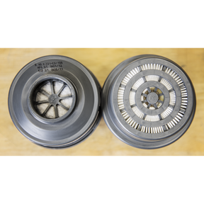 Top view of two cylindrical Sealey A2P3R Filter Cartridges (Pack of 2, product number 9366) on a wooden surface, one featuring a visible filter element for organic vapor protection and the other embellished with a circular pattern of metallic fins.