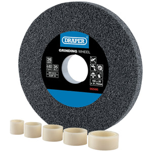 A gray Draper Aluminium Oxide Bench Grinding Wheel, 150 X 20mm, 36 Grit - BG15020C is shown alongside five white plastic bushings of varying sizes, ideal for coarse grit tool sharpening.