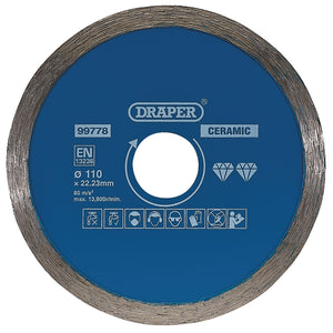 A blue circular ceramic cutting disc by Draper, identified as Draper Continuous Diamond Blade, 110mm - DBC1, with a 110mm diameter and 22.23mm bore, designed for angle grinders. It features various safety icons and specifications printed on the surface, making it ideal for cutting ceramic and natural stone tiles.
