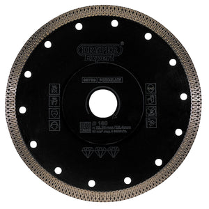 The Draper Expert Turbo-X Porcelain Diamond Blade, 180mm - DBX2 features a black surface with labeled text and a serrated turbo-x rim edge, ensuring precise cutting of materials such as porcelain and tile. It is ideal for use with angle grinders.