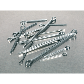 A scattered assortment of Sealey Split Pin Assortment 555pc Small Sizes Metric & Imperial - AB001SP lies on a metallic surface.