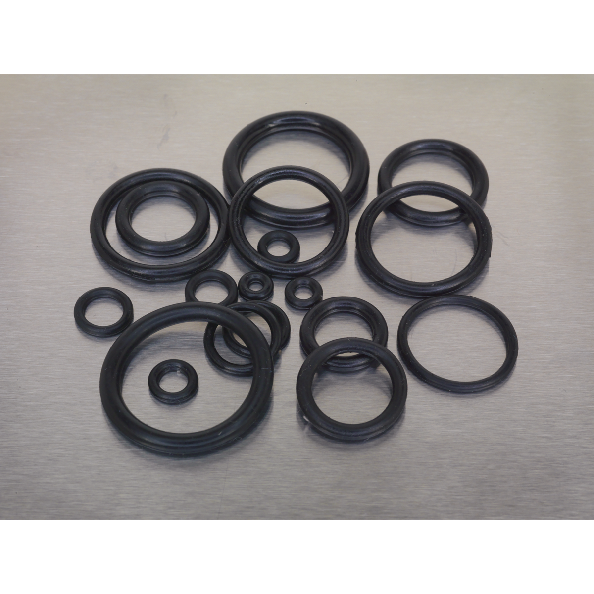 A 225-piece Rubber O-Ring Assortment (Metric) by Sealey (AB004OR) in various sizes is arranged in a cluster on a plain surface.