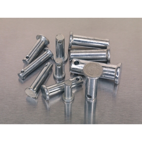 A collection of metallic round-ended cylindrical components with small holes, scattered on a grey surface. This Sealey Clevis Pin Assortment 200pc - Imperial (AB019CP) includes a total of 200 pieces.