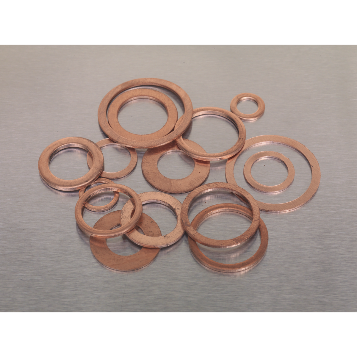 A 250-piece assortment of metric diesel injector copper washers from Sealey, product code AB027CW, arranged on a metallic surface.