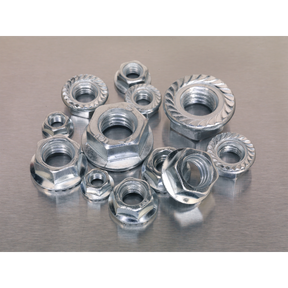 A collection of metallic nuts, including the Sealey Flange Nut Assortment 390pc M5-M12 Serrated Metric - AB031FN, displayed on a flat, reflective surface showcases an array of metric sizes conforming to DIN 6923 standards.