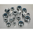 The Sealey Nylon Locknut Assortment 300pc M6-M12 Metric - AB032LN, featuring hex nuts with blue nylon inserts in various sizes, is neatly arranged in a partitioned box on a metallic surface.