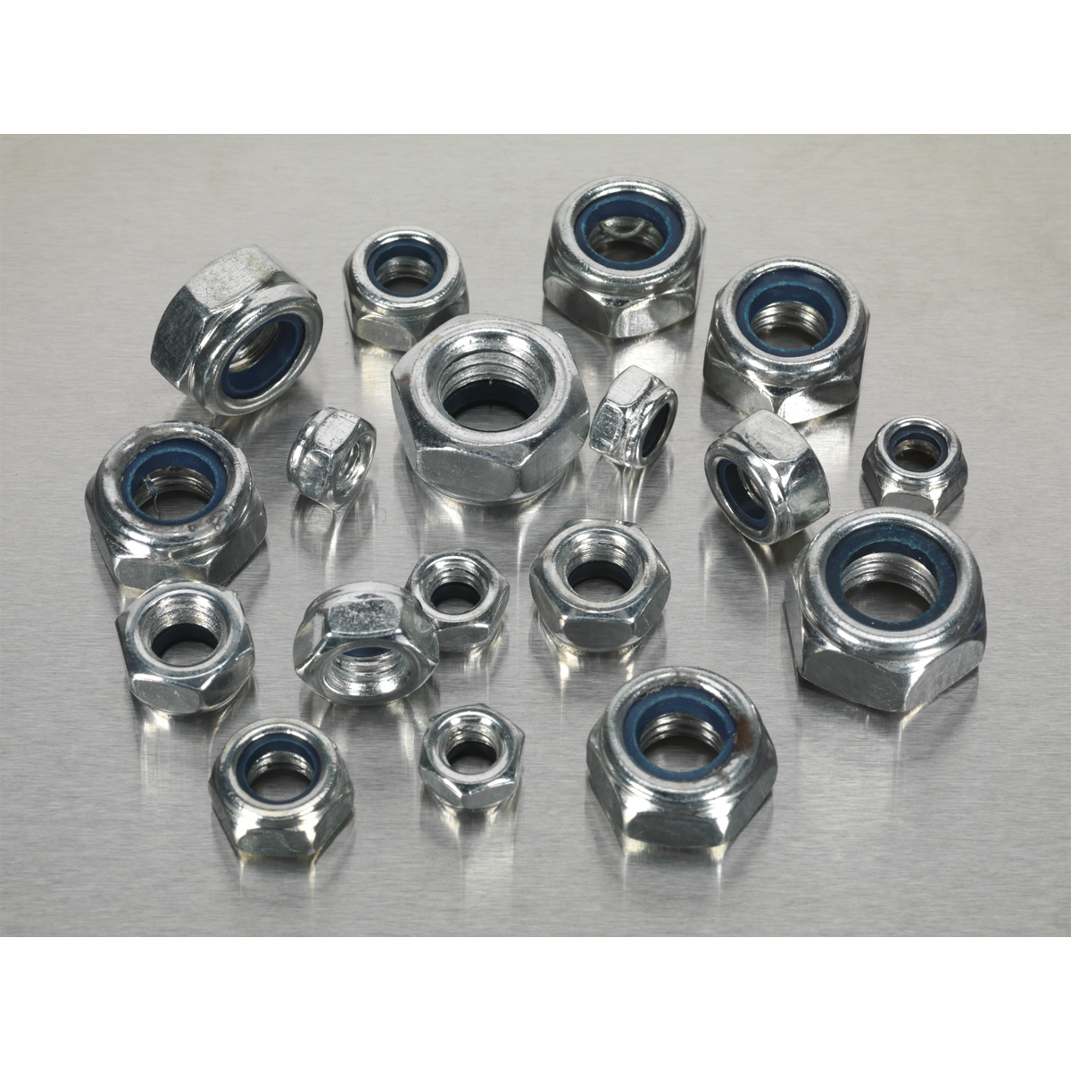 The Sealey Nylon Locknut Assortment 300pc M6-M12 Metric - AB032LN, featuring hex nuts with blue nylon inserts in various sizes, is neatly arranged in a partitioned box on a metallic surface.