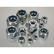 A Nylon Locknut Assortment 255pc M4-M16 - AB033LN by Sealey, featuring Metric DIN 985 metallic hex nuts with inner blue rings, neatly organized in a partitioned box, displayed on a silver surface.