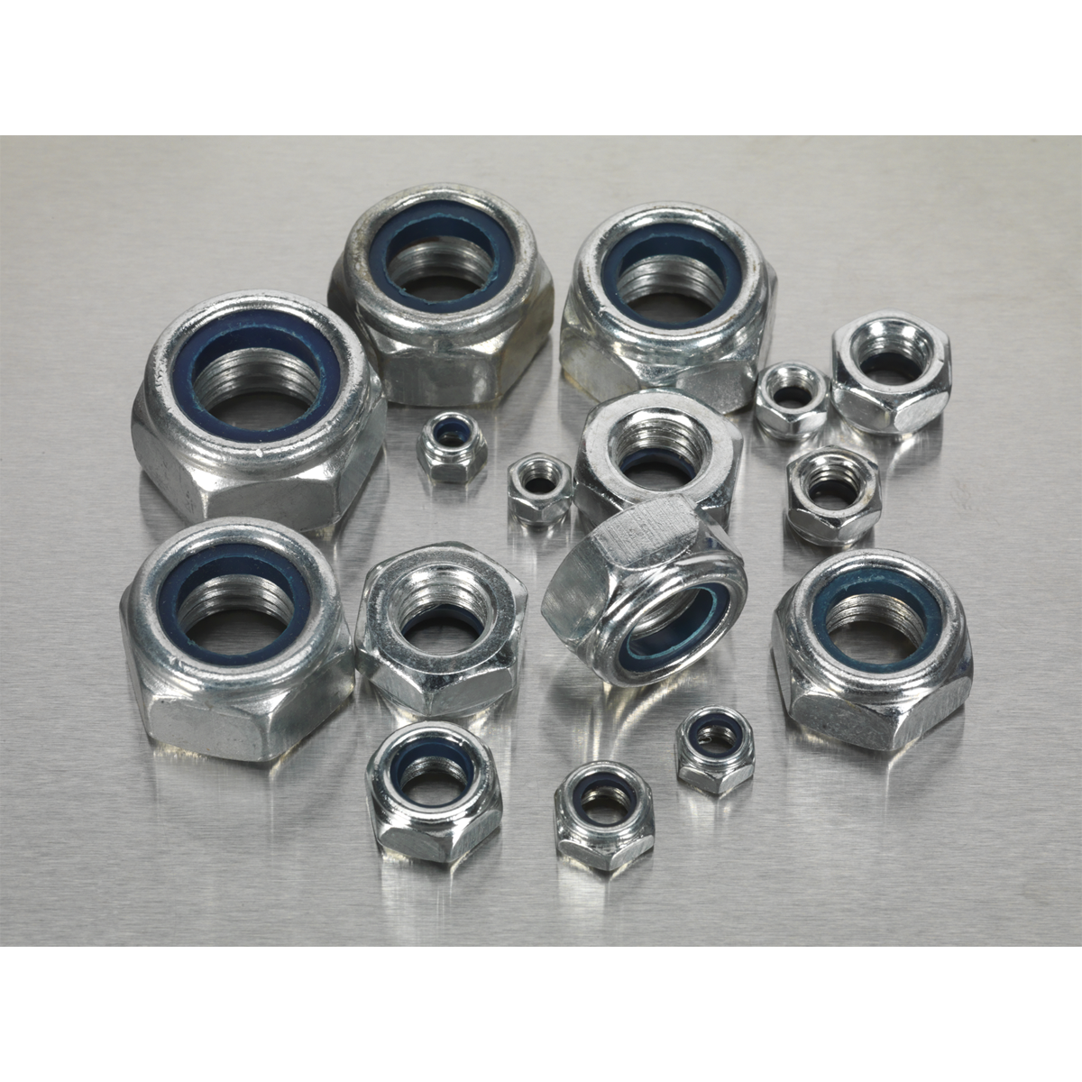 A Nylon Locknut Assortment 255pc M4-M16 - AB033LN by Sealey, featuring Metric DIN 985 metallic hex nuts with inner blue rings, neatly organized in a partitioned box, displayed on a silver surface.