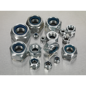 A Nylon Locknut Assortment 255pc M4-M16 - AB033LN by Sealey, featuring Metric DIN 985 metallic hex nuts with inner blue rings, neatly organized in a partitioned box, displayed on a silver surface.