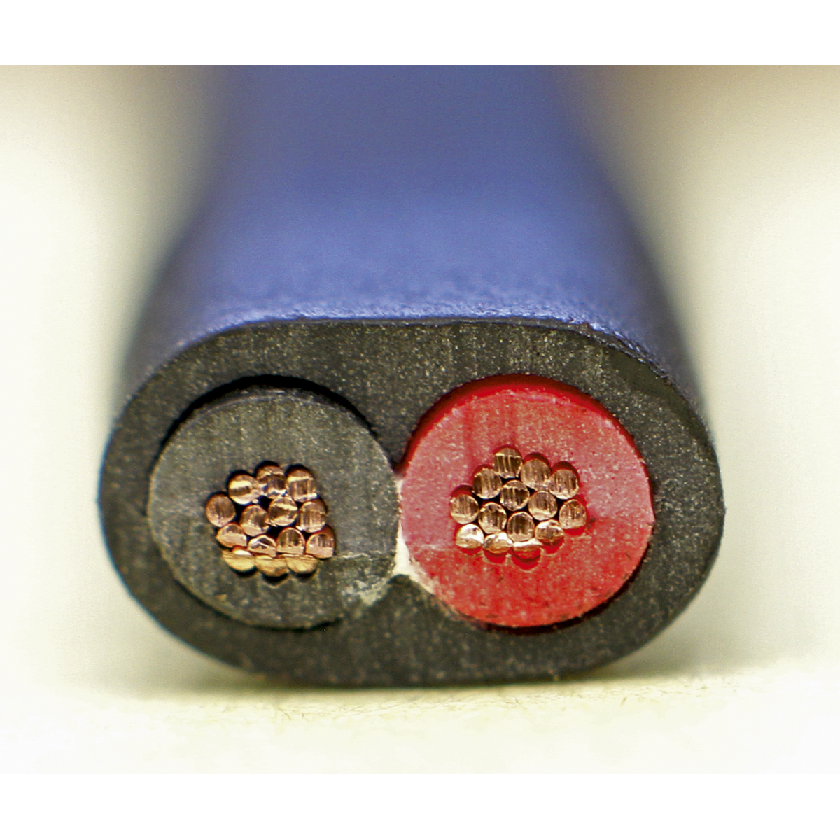 Close-up of a cut section of the Sealey Automotive Cable Thin Wall Flat Twin (2 x 1mm², 32/0.20mm, 30m, Black - AC3220TWTN), showcasing the twin core conductor with copper strands insulated by black and red sheaths, encased in an outer protective black jacket.