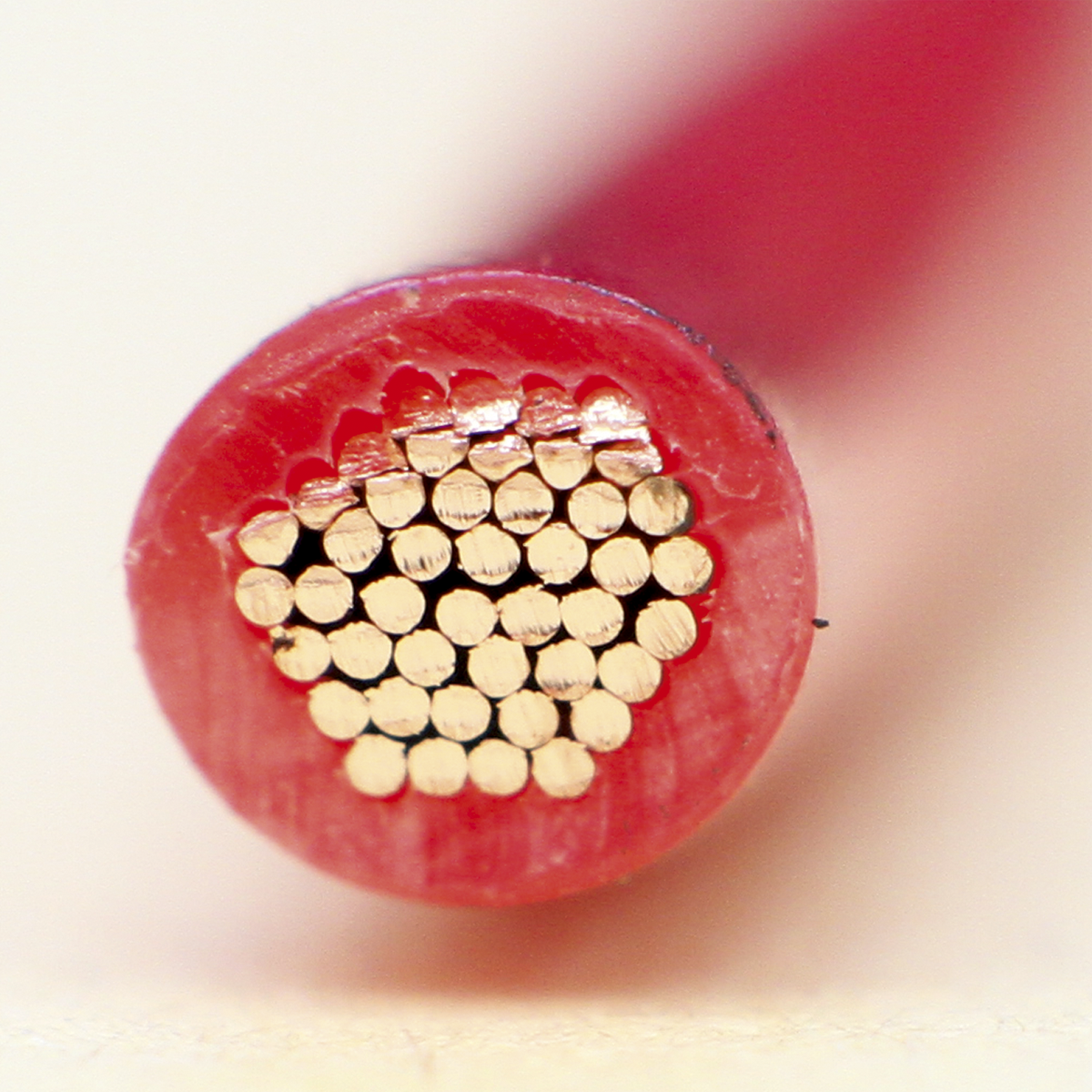 Close-up view of the cross-section of a Sealey Automotive Cable Thin Wall Single 3mm² 44/0.30mm 30m Red - AC4430RE, revealing internal single core conductors and its RoHS compliance.