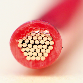 Close-up view of the cross-section of a Sealey Automotive Cable Thin Wall Single 3mm² 44/0.30mm 30m Red - AC4430RE, revealing internal single core conductors and its RoHS compliance.