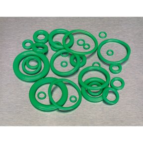 A collection of Sealey's Air Conditioning Rubber O-Rings, 225 pieces in various metric sizes, meticulously arranged on a gray surface. These green HNBR O-rings are ideal for automotive air conditioning systems using Freon R134a.