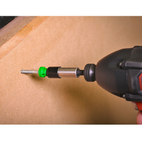 Using the Sealey Power Tool Bit Pozi #2 with Magnetic Holder S2 25mm (Pack of 5 - AK210521), a power drill drives a screw into a piece of wood, featuring high-quality S2 steel and a convenient green and black design.