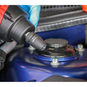 Close-up of a person wearing a blue glove using a Sealey Impact TRX-Star* Female Socket Set 10pc 1/2"Sq Drive (AK2301) with an electric wrench to tighten a bolt on a blue automotive part.