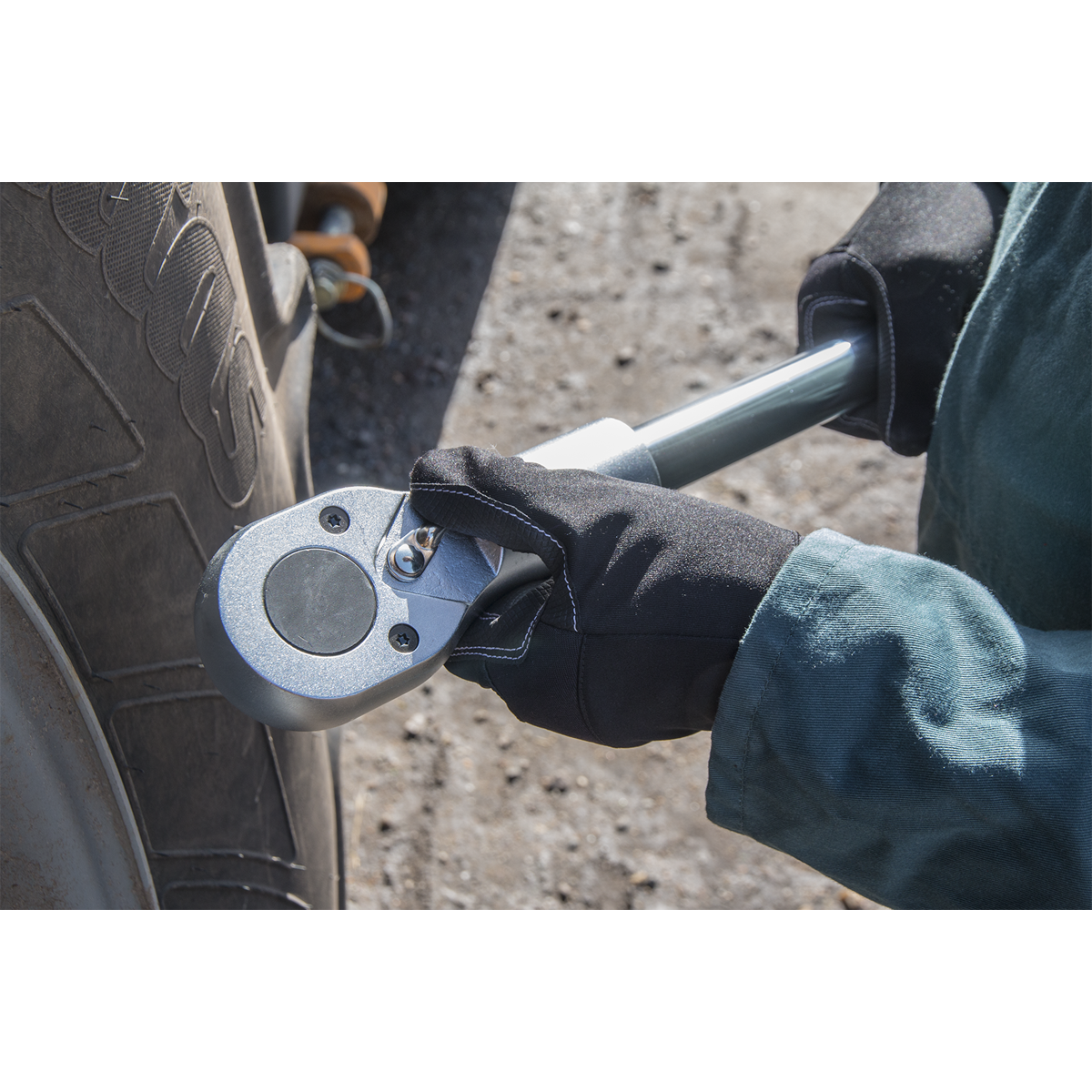 A person using the Sealey Socket Set 22pc 1"Sq Drive 6pt WallDrive® Metric - AK261 to tighten a bolt on a vehicle tire.