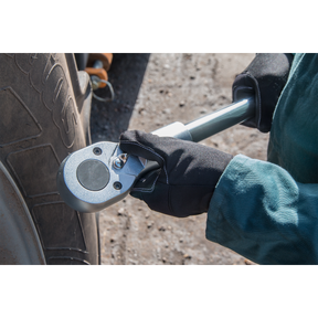 A person using the Sealey Socket Set 22pc 1"Sq Drive 6pt WallDrive® Metric - AK261 to tighten a bolt on a vehicle tire.