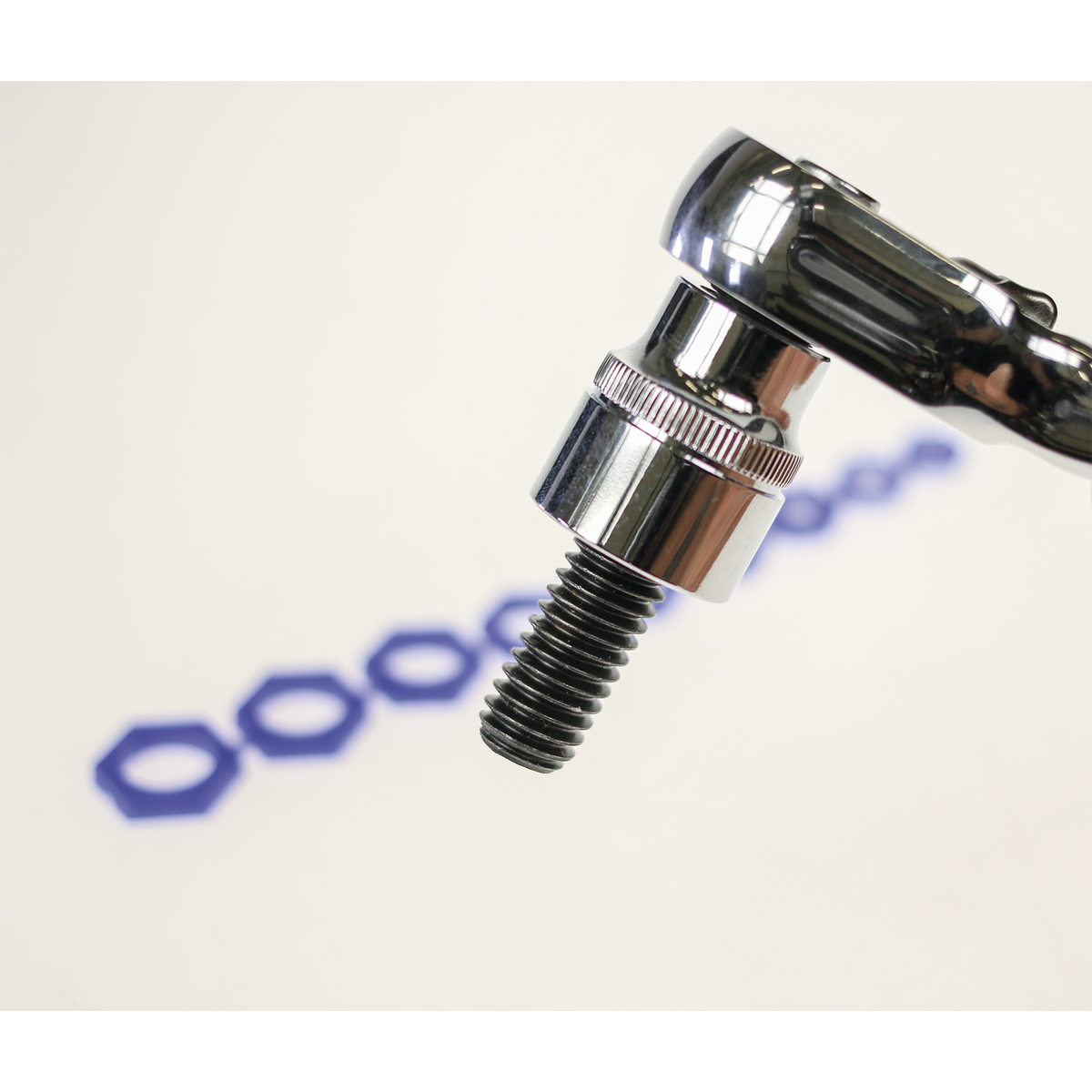 Close-up of a Sealey wrench gripping a screw, with a row of blue hexagonal shapes in the blurred background and the Magnetic Socket Insert Set 10pc Metric - AK27095 retaining fasteners securely.