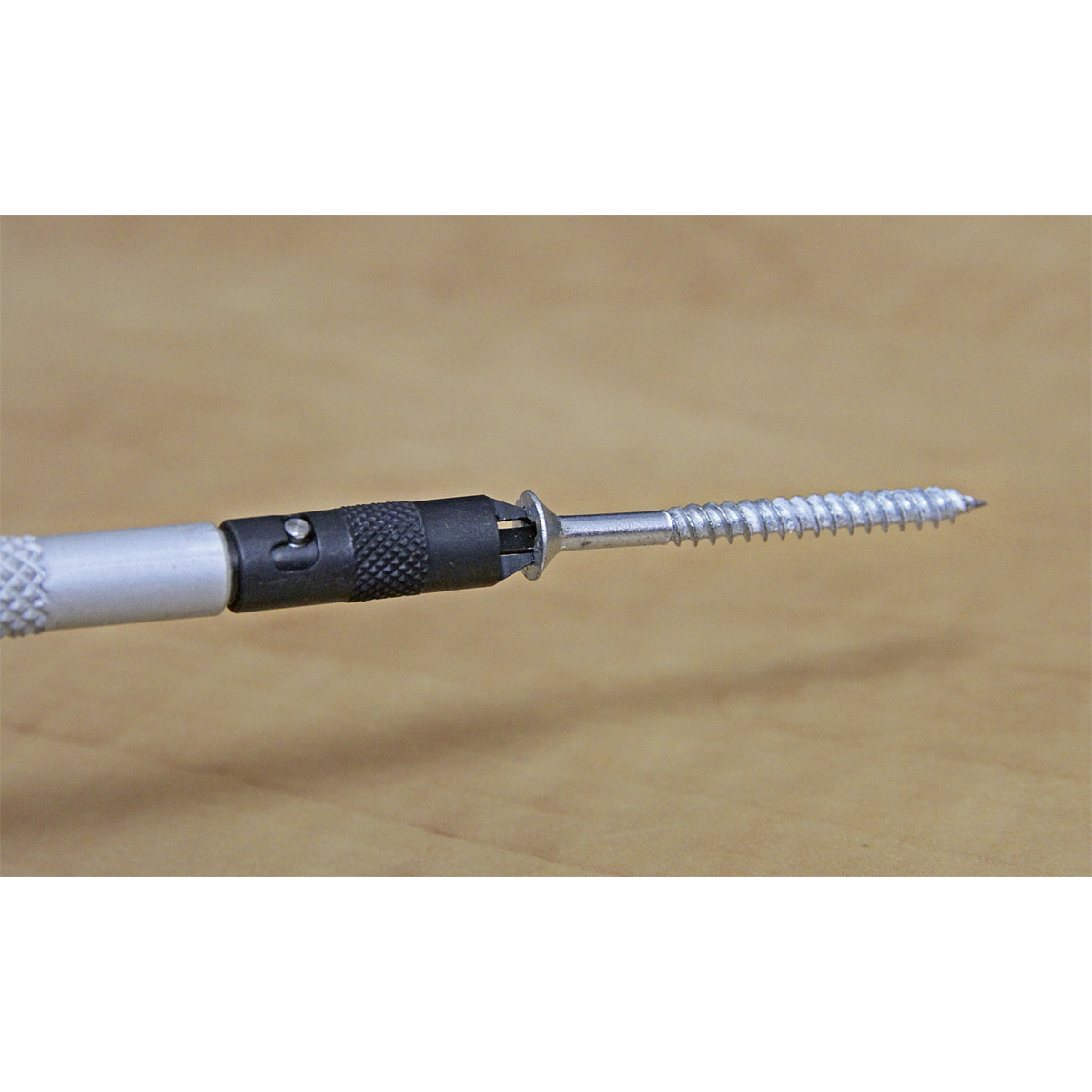 Close-up of a Sealey Screw Starter Double End - AK4318 gripping a screw, against a plain background.