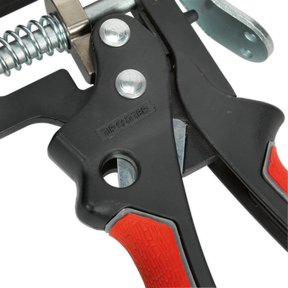 Close-up of a Sealey Caulking Gun 280mm Heavy-Duty - AK4803, featuring black metal construction with red and black handles, a visible spring mechanism, and an integrated tip cutter for precise work on 310ml cartridges.