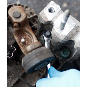 A gloved hand uses a Sealey Spline Bit M14 x 30mm Pack of 2 (AK5532) to loosen a bolt on a piece of machinery.