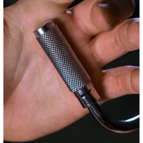 A hand holding a textured metallic cylinder made from Chrome Vanadium steel, with a curved hook attached at the bottom. This Speed Brace 3/8" Sq Drive - AK5694 by Sealey comes with a lifetime guarantee, ensuring durability and quality.