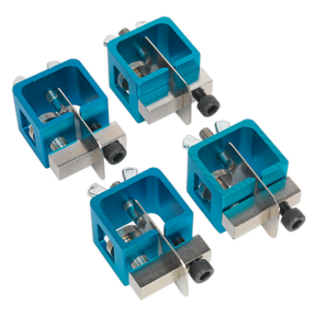The Sealey Butt Welding Clamp Set 4pc - AK6805 includes four blue and silver metal clamps arranged in a grid pattern. Featuring adjustable screws for level adjustment, these clamps are ideal for accommodating different thickness materials. Their rectangular design with a hollow center ensures precise alignment for evenly spaced butt weld joints.