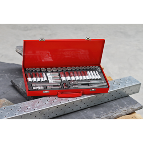 A Sealey Socket Set 45pc 3/8"Sq Drive 6pt WallDrive® - Metric/Imperial (AK692) sits in a red metal toolbox with the lid open, revealing a professional assortment of wrenches and other tools crafted from Chrome Vanadium steel, placed on a piece of metal next to a perforated metal beam. This durable collection guarantees reliability and performance with a lifetime guarantee.