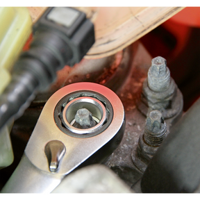 Close-up of a Sealey AK6926 Go-Through Low Profile WallDrive® Metric Socket Set fitting onto a bolt with a hexagonal head, positioned among other bolts and car engine components, showcasing the durability of Chrome Vanadium steel.