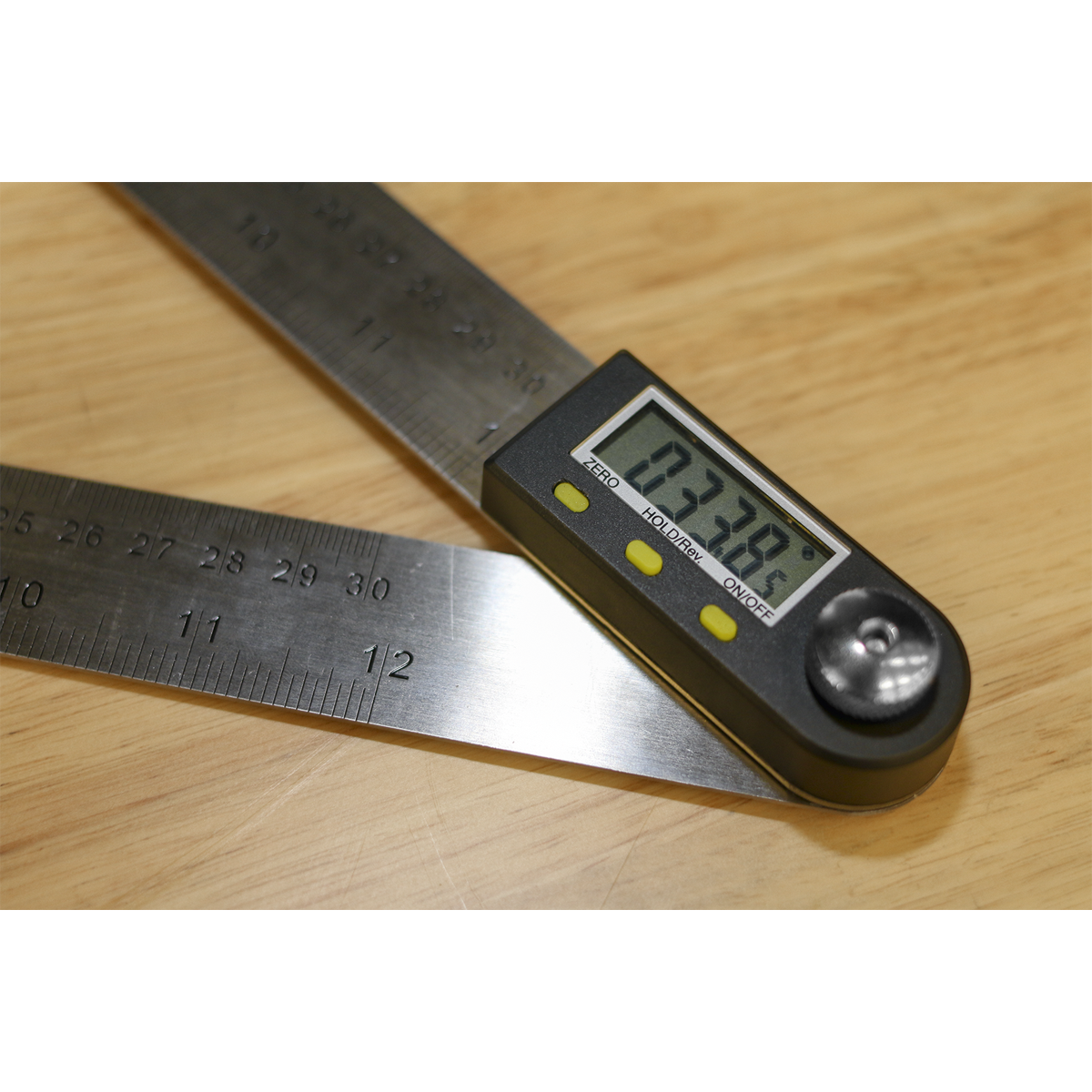 The Sealey Digital Angle Rule 300mm (12") - AK7300 features an LCD display that shows a precise measurement of 137.9 degrees. Ideal for woodworking projects, it is used on a wooden surface.