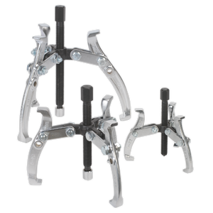 Three metal gear pullers of varying sizes, part of the Sealey Gear Reversible Puller Set 3pc Triple Leg - AK78, are arranged on a plain background. Each puller, crafted from drop-forged Chrome Vanadium steel, features adjustable arms and a central screw mechanism with hex head forcing screws.