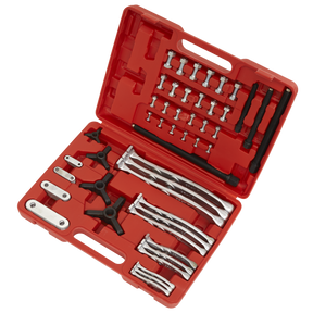 The Sealey Gear Reversible Puller Set 4pc Triple Leg - AK79 includes a red plastic toolbox equipped with various metal puller tools, such as drop-forged steel bars, screws, and connectors, neatly organized in compartments. The set also features robust reversible legs crafted from Chrome Vanadium for superior durability.